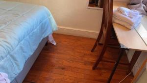 a bedroom with a bed and a wooden floor at 2218NColoradoC in Philadelphia