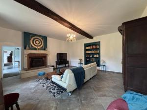 a living room with a couch and a fireplace at Gîte de charme à Souvigny avec jardin et animaux admis - FR-1-489-581 in Souvigny