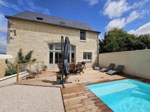 un cortile con piscina e una casa di Charmant Gîte 6 Pers avec Piscine Privée et Jardin, Avon-les-Roches - FR-1-381-629 a Avon-les-Roches