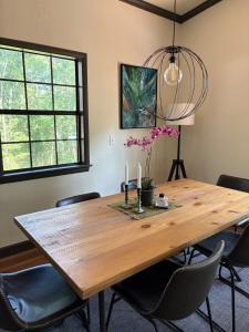 Un comedor con mesa y sillas de madera. en Modern Mountainside Cabin, en Bella Vista