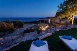 a house with a view of the ocean at night at Astounding Hvar Villa 4 Bedrooms Villa Crystal Hvar 1 Mesmerizing Sea Views & Private Infinity Pool in Hvar
