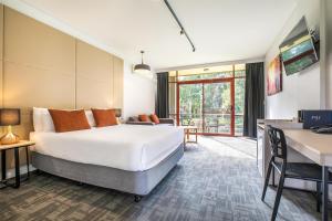 a hotel room with a bed and a living room at Nightcap at York on Lilydale in Mount Evelyn