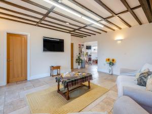 a living room with a couch and a table at One Chainbridge Barns in Skegness
