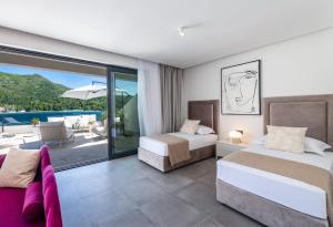 Postel nebo postele na pokoji v ubytování Captivating Dubrovnik Villa Villa Belle Riviere Private Infinity Pool + 32 fotografií