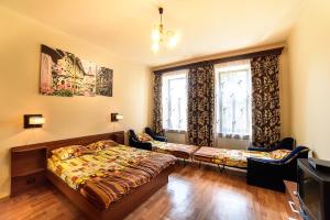a bedroom with two beds and a tv and a window at Apartments Nekrasova-Rufa 23 in Lviv