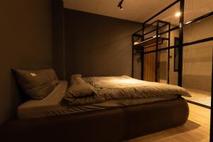 a bedroom with a bed in a dark room at Midas Home in Da Lat