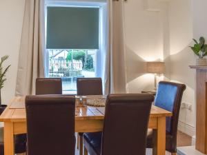 a dining room with a table and chairs and a window at Ty Ni in Bala