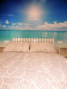 a white bed with a view of the ocean at Atico la cascada de conil in Conil de la Frontera