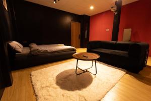 a living room with a couch and a table at Midas Home in Da Lat