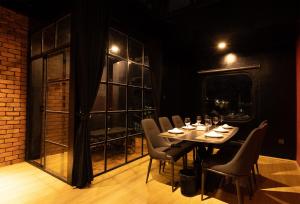 a dining room with a table and chairs and a window at Midas Home in Da Lat
