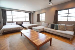 a living room with a couch and a table at TABISAI HOTEL Premium 博多-中洲 in Fukuoka