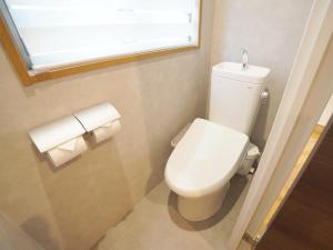 a bathroom with a toilet and two rolls of toilet paper at TABISAI HOTEL Premium 博多-中洲 in Fukuoka +36 photos