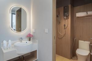 a bathroom with a sink and a toilet and a mirror at Emerald Hotel Residence in Phnom Penh +19 photos