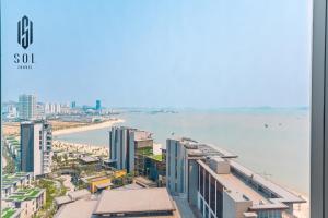 a view of a city with the ocean and buildings at À La Carte Homestay By Sol Travel in Kon Rung (1)