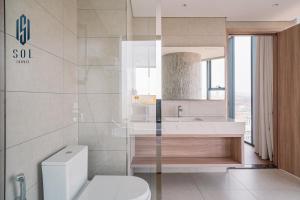 a bathroom with a white toilet and a sink at À La Carte Homestay By Sol Travel in Kon Rung (1) +7 photos