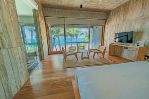 a bedroom with a bed and a table and chairs at Private Suite, The Coast Sri Lanka in Induruwa +14 photos