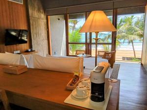a coffee maker on a table in a living room at Private Suite, The Coast Sri Lanka in Induruwa