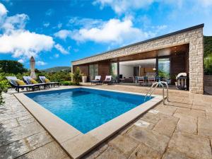 une piscine dans l'arrière-cour d'une maison dans l'établissement Frontline Korcula Villa A Stones Throw To The Beach Villa Korcula Bay View, à Korčula