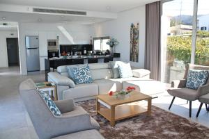 a living room with a couch and chairs and a table at Luxury Calheta Villa Casa Calheta Heights 3 Bedrooms Stunning Sea Views in Calheta