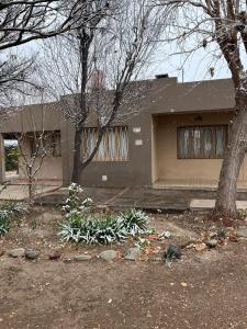 a house with two trees in front of it at Complejo Los Abuelos in San Rafael