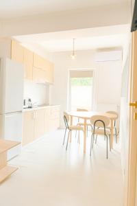 a kitchen and dining room with a table and chairs at DD Apartments - Iuliu Moldovan in Cluj-Napoca