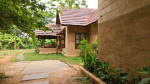 a house with a red roof and a yard at The Lilac Farm in Sāslu