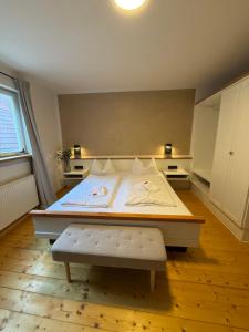 a bedroom with a bed and a bench in it at Lehm & Stil - Nachhaltig und rustikal in Marktbreit +4 photos