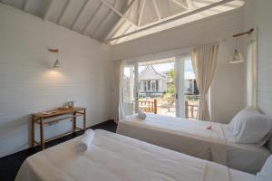 Postel nebo postele na pokoji v ubytování Paus Putih Hotel