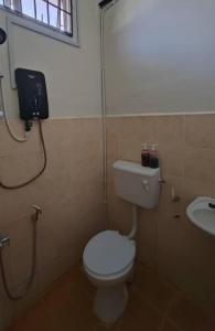 a bathroom with a toilet and a sink at Rossa Homestay, Kok Lanas in Kampong Kok Lanas