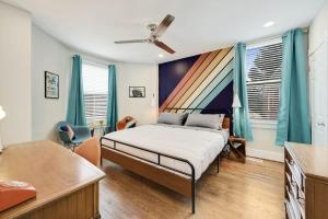 a bedroom with a bed in a room with blue curtains at Mid-Century Townhome Steps from Restaurants #DCottage in Washington +13 photos