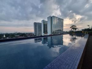 a swimming pool on the roof of a building at Studio Room Apartment with Pool in Yogyakarta