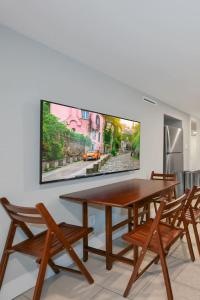 a dining room with a wooden table and chairs at Cozy Mid-Century Apartment Steps From Restaurants #DCottage in Washington