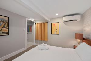 a bedroom with two white beds and a window at Cozy Mid-Century Apartment Steps From Restaurants #DCottage in Washington