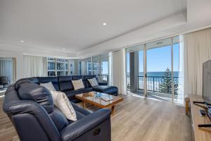 a living room with a couch and a table at Oceana On Broadbeach in Gold Coast