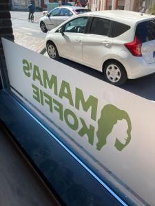 a sign for a carazonazon sign on a car dealership at Gezellig boven Mama's Koffie in het centrum van Roeselare in Roeselare