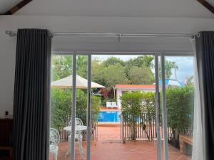 an open patio door with a view of a pool at NanaSky Kampot Residence 