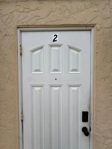 a white garage door with the number two on it at Apartment in Bonita in Bonita Springs