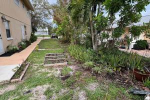 a yard with some plants and a house at Apartment in Bonita in Bonita Springs