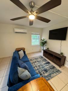 a living room with a blue couch and a flat screen tv at Apartment in Bonita in Bonita Springs