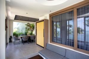 a living room with a blue couch and a table at Encantada Residences in Boracay