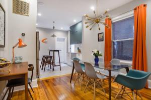 a dining room and living room with a table and chairs at Mid-Century Marvel Steps from Restaurants Bars and Markets 3BR & 2BA in Washington