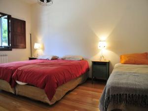 a bedroom with two beds with red blankets and two lamps at Beautiful Ponte De Lima Villa 4 Bedrooms Villa Hermosa Vista Private Pool in Ponte de Lima
