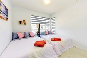 two white beds in a room with a window at Brand New 7beds-kingbedsfamilysleep15playtable in Milton