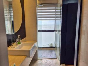 a bathroom with a sink and a glass shower door at Goldcoast Palm Tree Sepang Luxury Resort in Sungai Pelik +47 photos