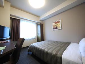 Postel nebo postele na pokoji v ubytování Hotel Route-Inn Satsumasendai + 20 fotografií