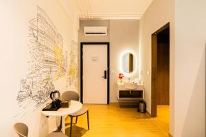 a bathroom with a drawing on the wall at Emerald Hotel Residence in Phnom Penh +19 photos