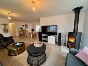 a living room with a couch and a fireplace at ROBE TWO FIVE - Pet friendly outside WiFi in Robe