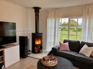 a living room with a couch and a fireplace at ROBE TWO FIVE - Pet friendly outside WiFi in Robe