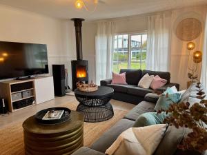 a living room with a couch and a fireplace at ROBE TWO FIVE - Pet friendly outside WiFi in Robe +22 photos