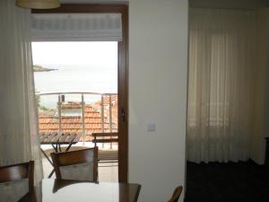 a room with a table and a view of the ocean at Anteya Serdika Apartments in Sozopol